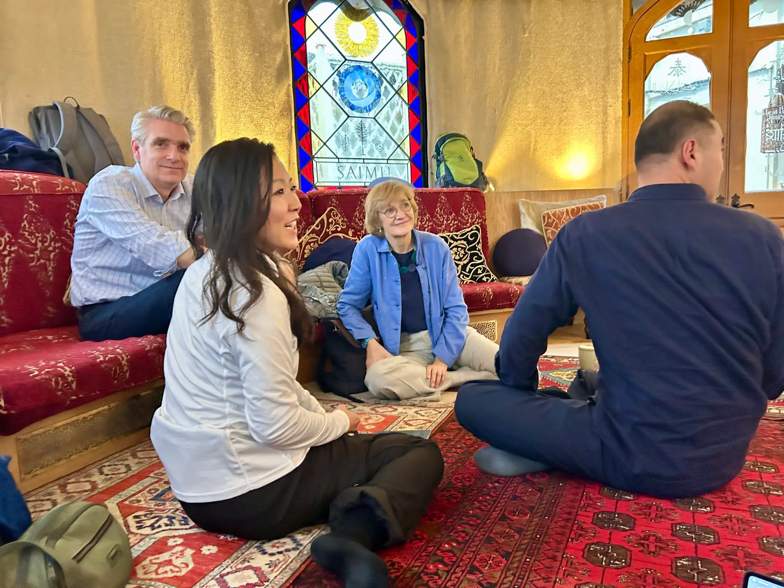 Participants from Japan and the UK in reflective dialogue under a Bedouin tent at St Ethelburga’s Centre, exploring regenerative leadership and connection to nature.